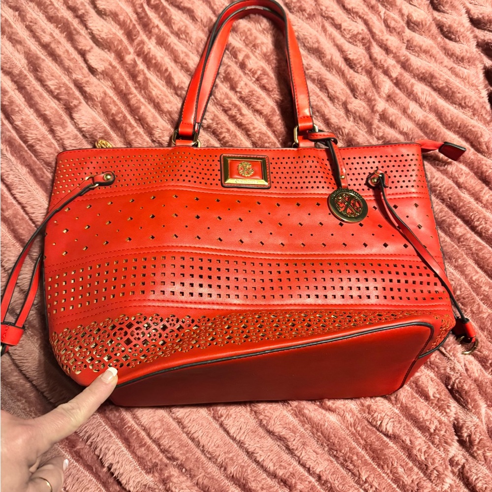 Red Christian Lacroix Perforated Handbag. Handles have wear and tear